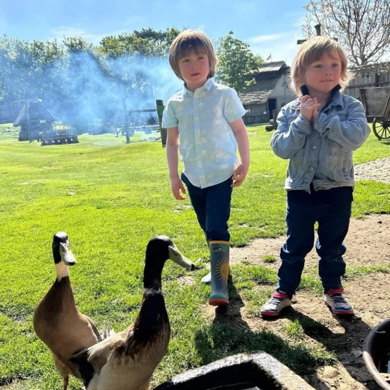 Two boys exploring castle grounds and feeding ducks