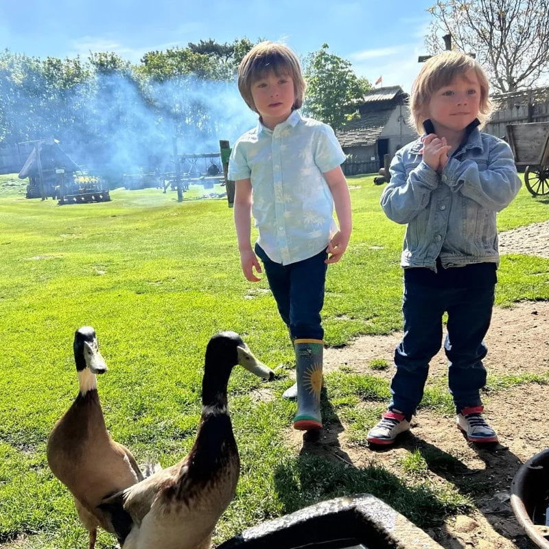 Two boys exploring castle grounds and feeding ducks