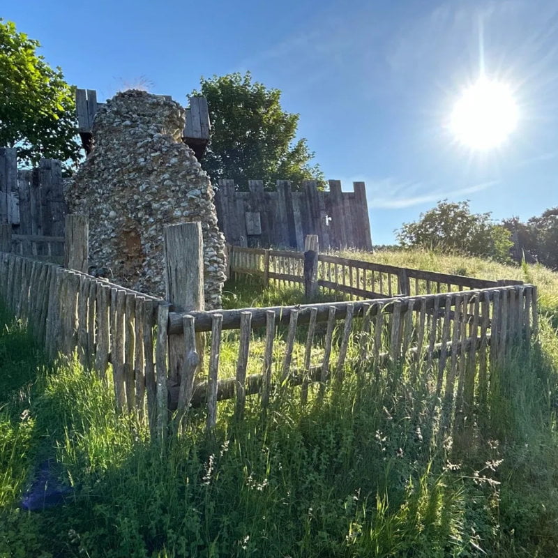 Fenced off remains at Mountfitchet Castle with the rising sun