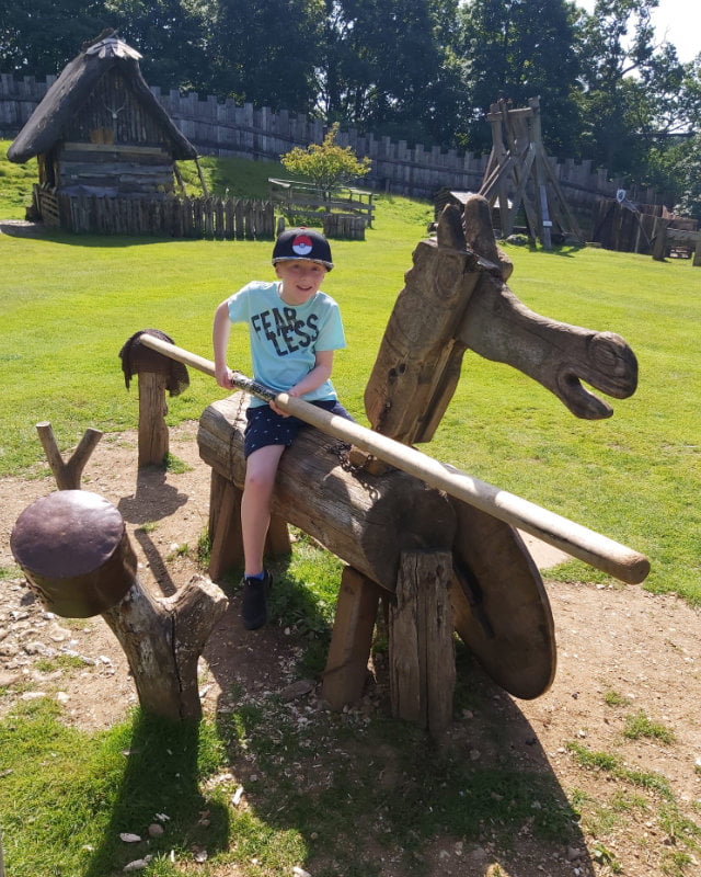Boy playing at jousting on a wooden hourse